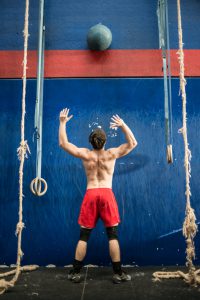 Grugliasco, Italy - December 20, 2015: A young man practising medicine ball techniques during a gym class in the Italian gym Gym "La Mole".